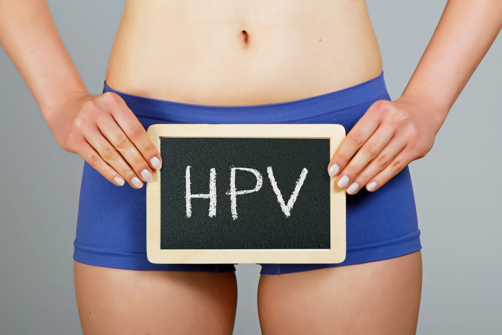 uma pessoa segurando uma placa escrito HPV segurando de frente para o quadril. o que é hpv